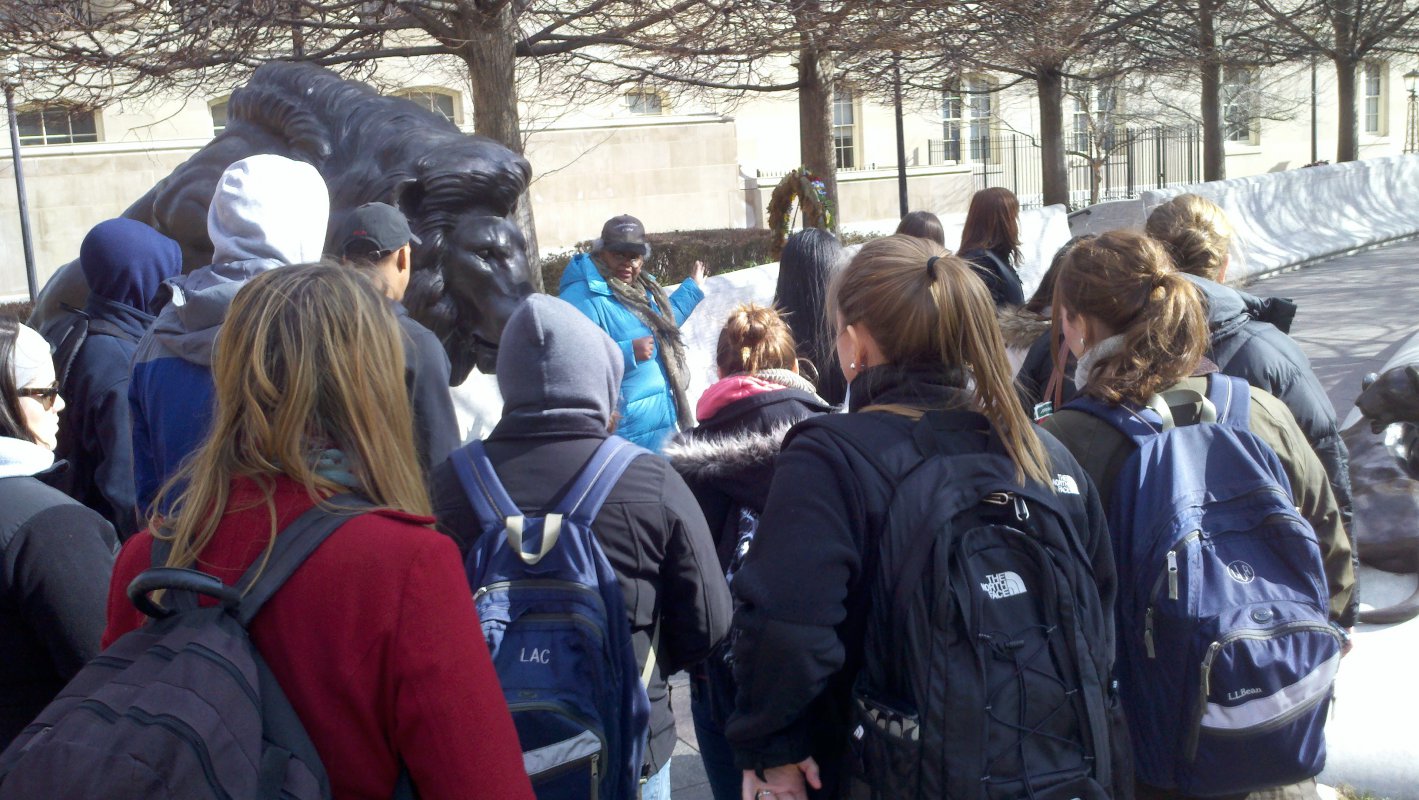 Dr. Daughtery explains to students how this lion outside the National Building Museum is an example of an attempt to infuse neo-classical style into what is essentially a modern style.